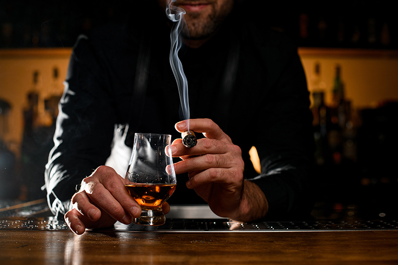 Man Smoking Cigar at Bar